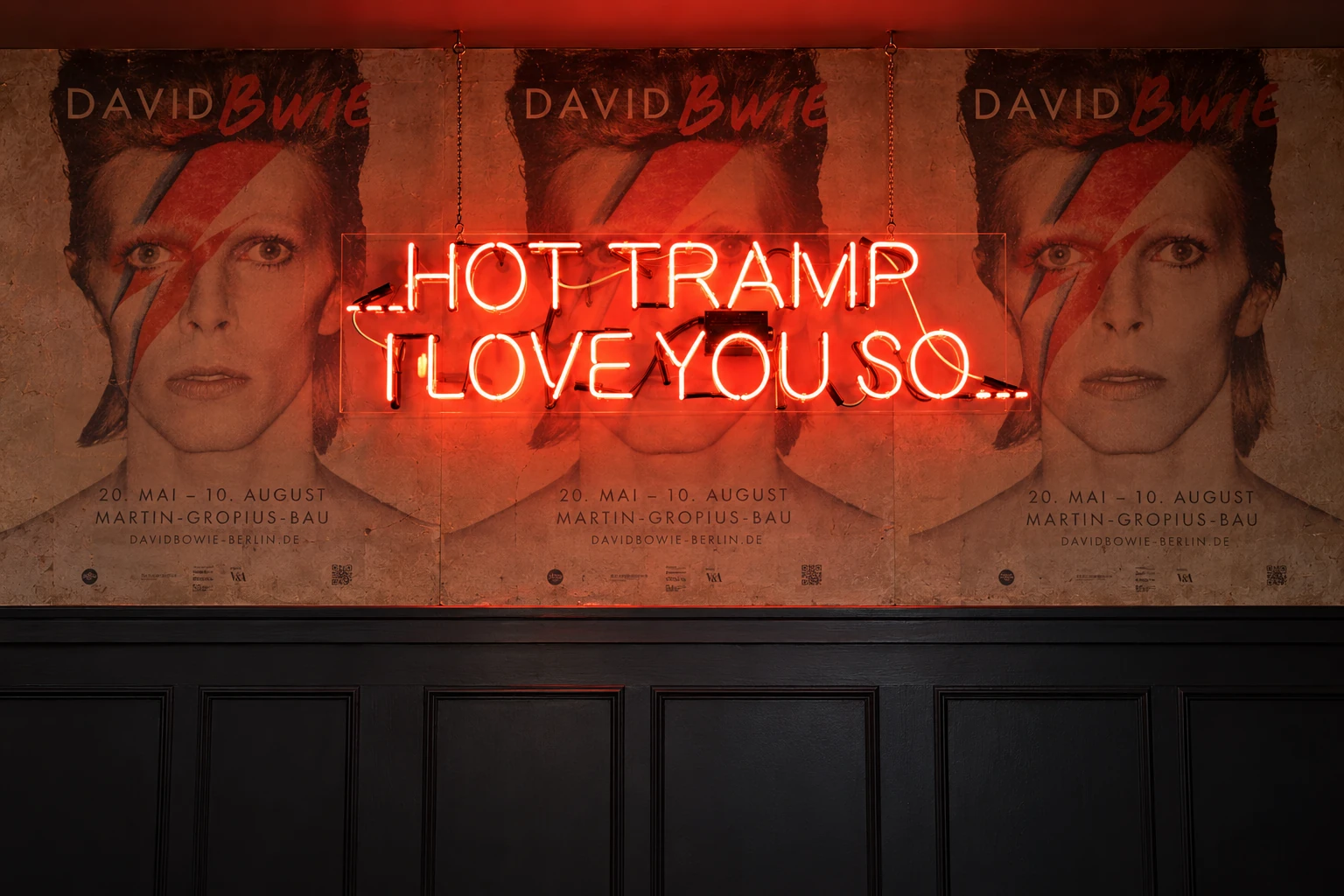 Hot Tramp neon signage design against three David Bowie posters